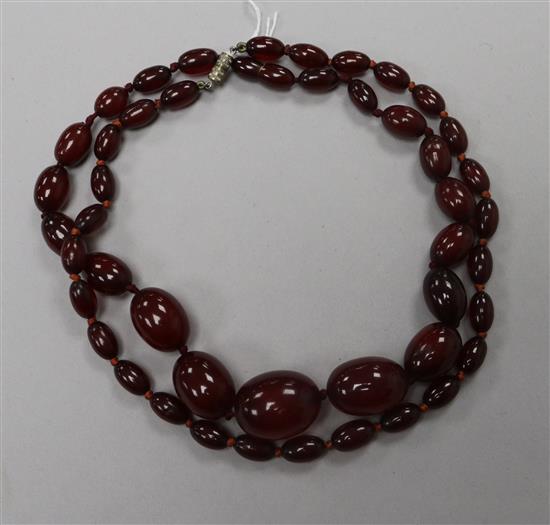 Two simulated cherry amber necklaces.